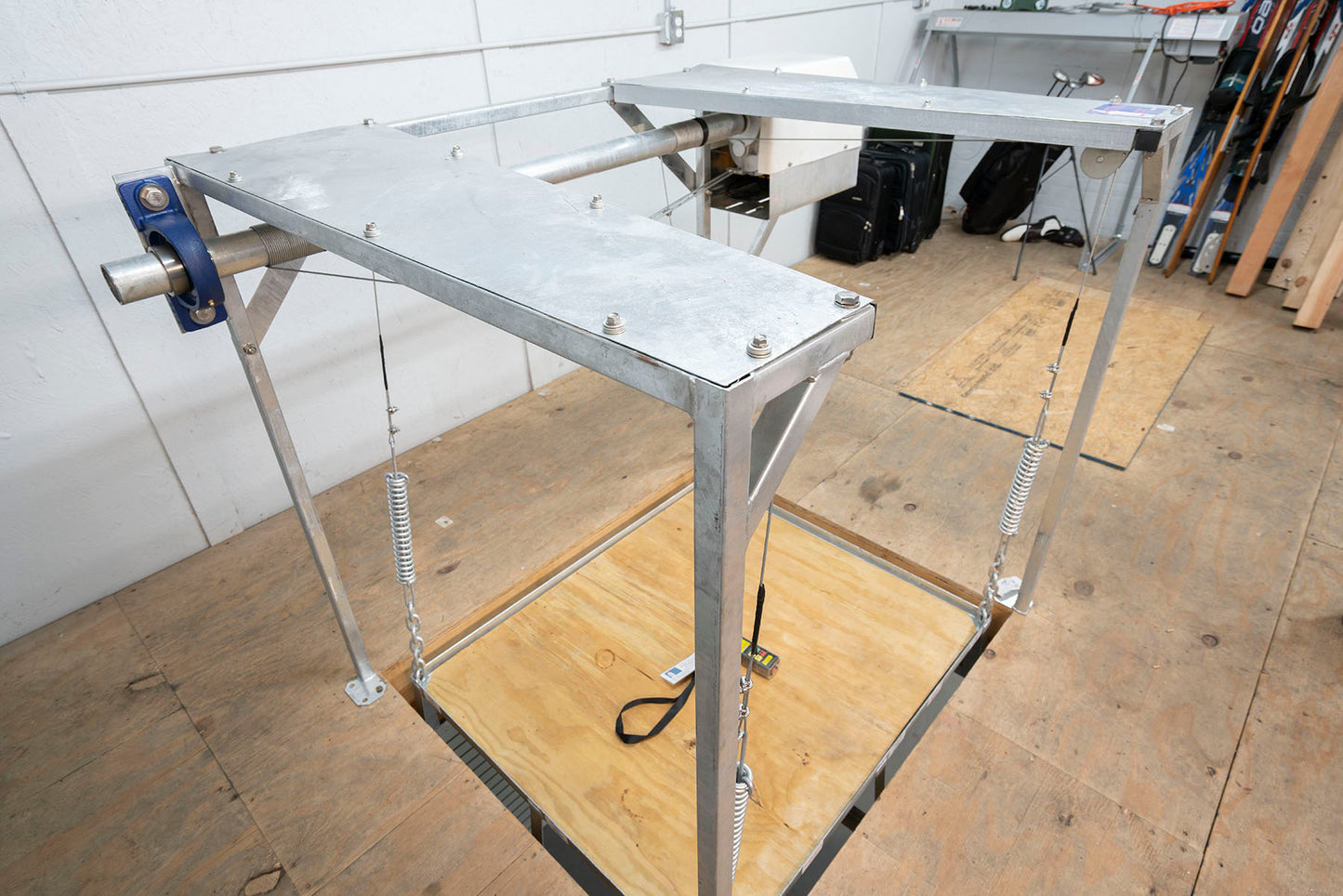 Weather-resistant attic lift with steel frame and wooden platform