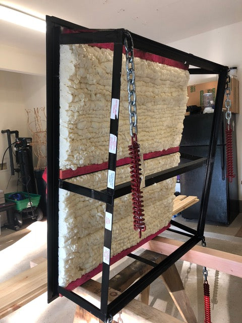 Side view of attic lift gate insulated with thick closed-cell foam and red weather stripping