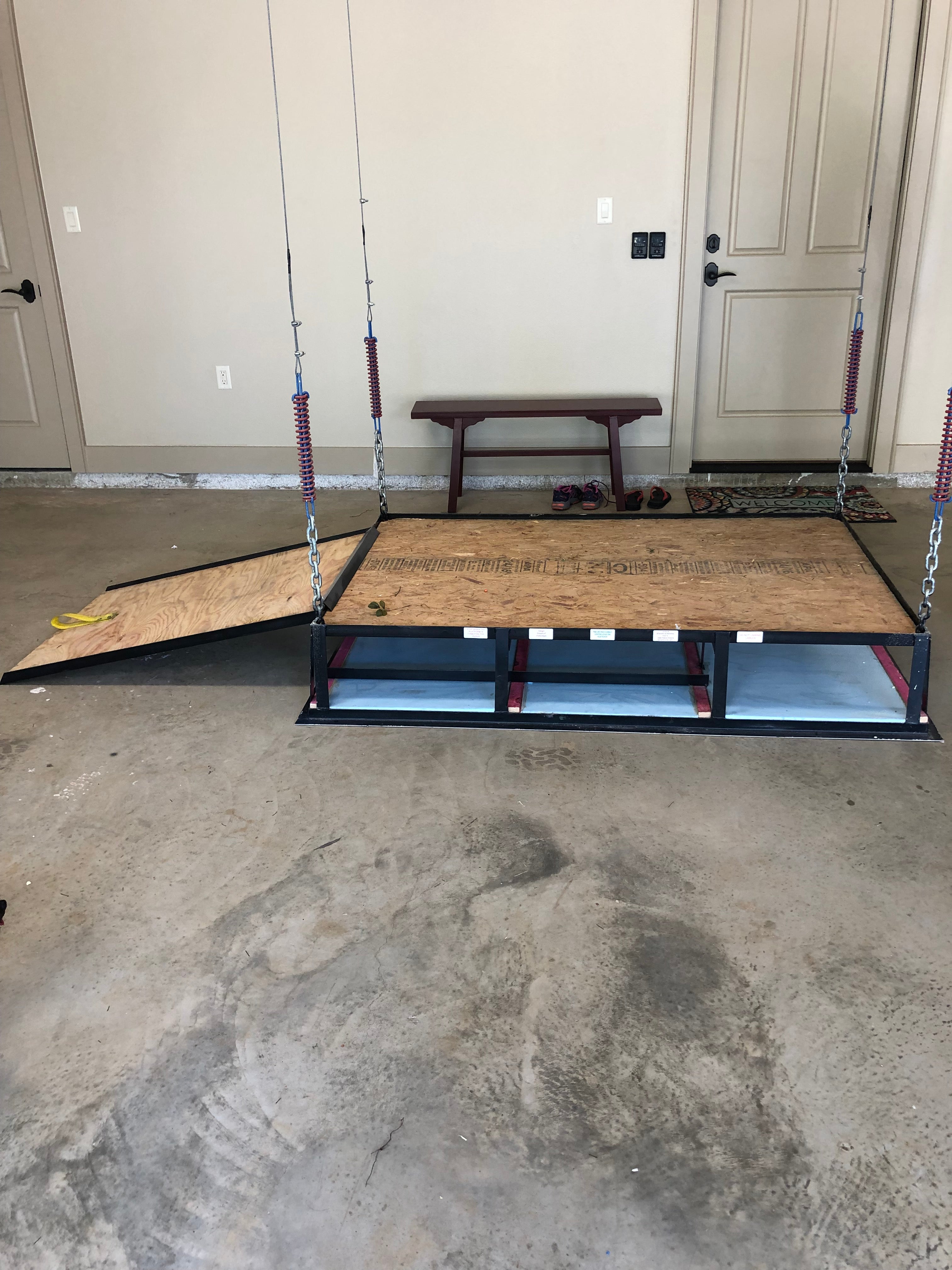 Garage attic lift with extended side ramp, suspended by chains and springs