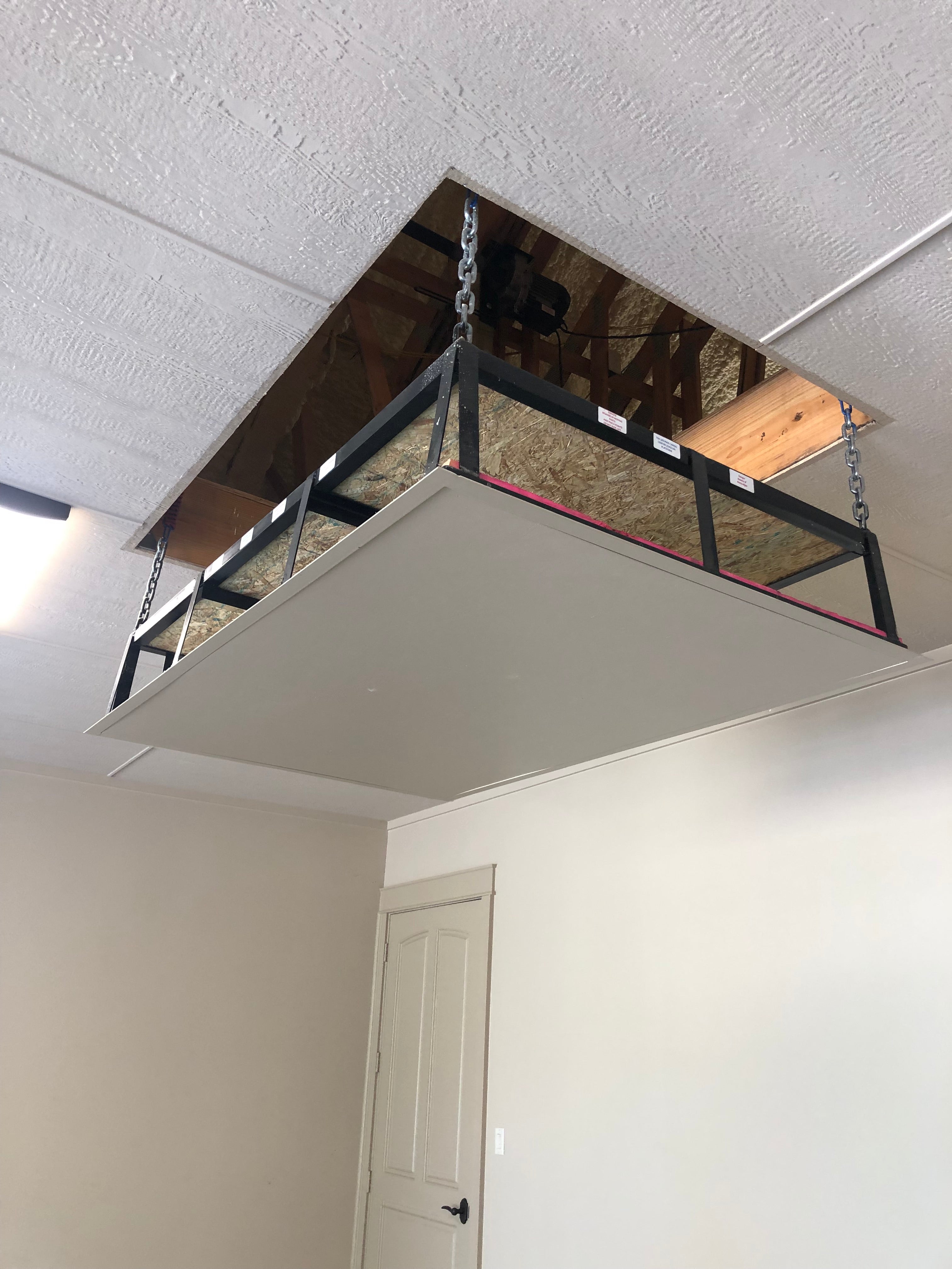Attic lift platform suspended from ceiling opening by chains